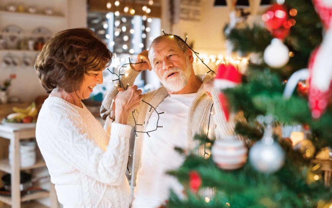 cute elderly couple putting up lights