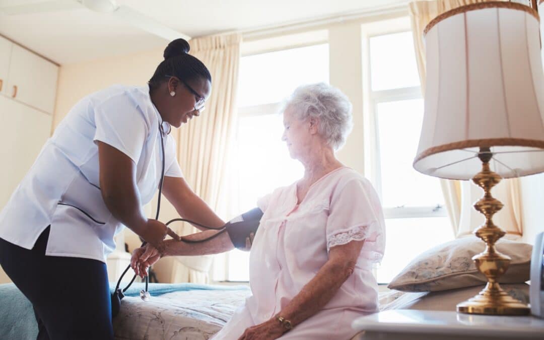 An elderly woman having her blood pressure checked by a nurse