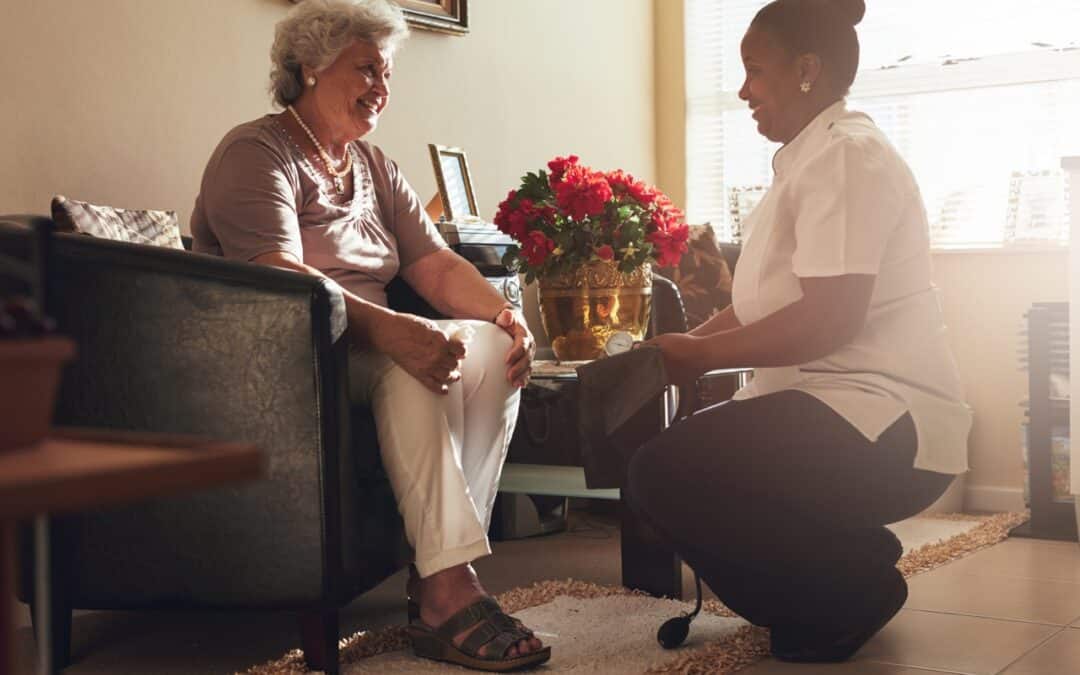 A female nurse visiting a senior in a skilled nursing facility