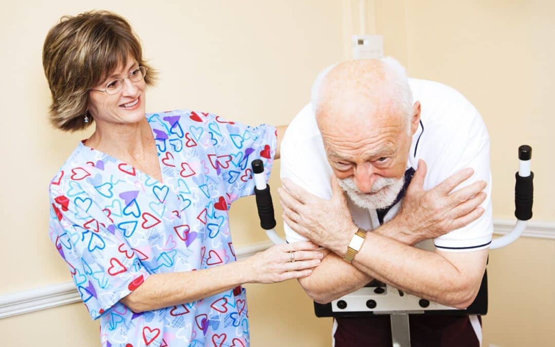 A physical therapist assisting an elderly man with physical exercises