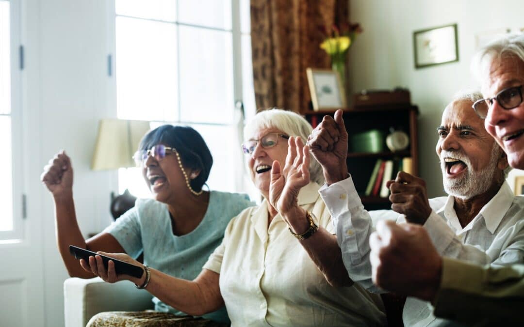 Seniors watching a movie together in an assisted living facility