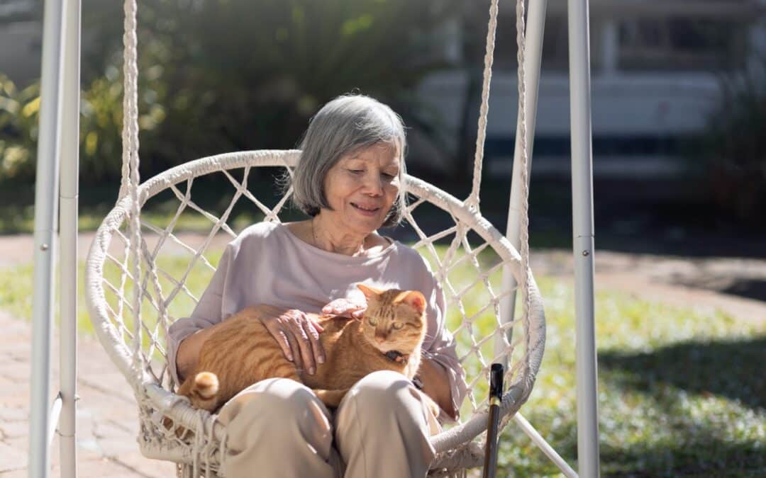 An elderly woman with a cat on her lap