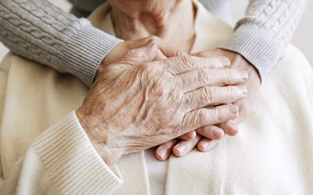 an elderly woman being comforted by a nurse