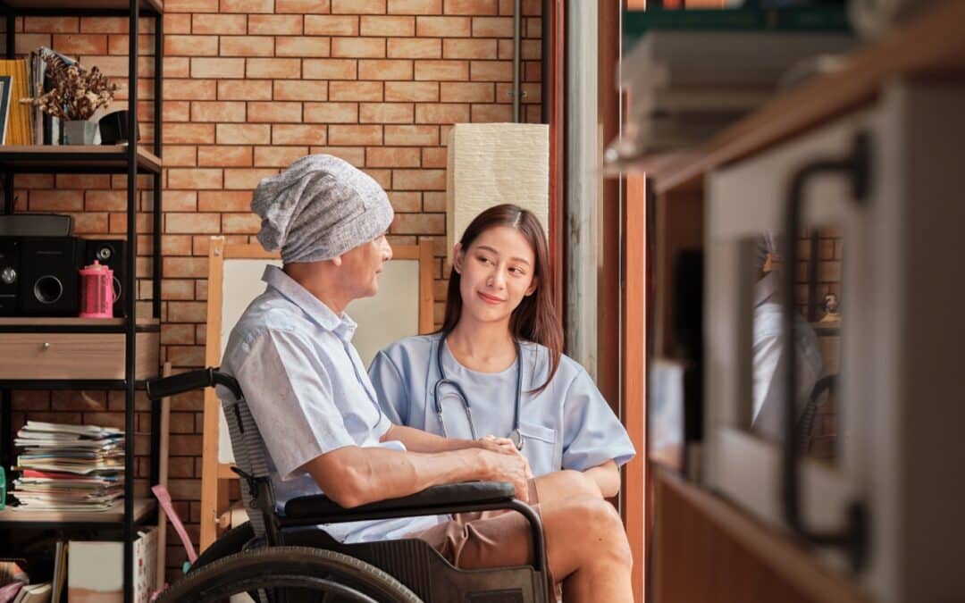 A nurse looking after a senior cancer patient