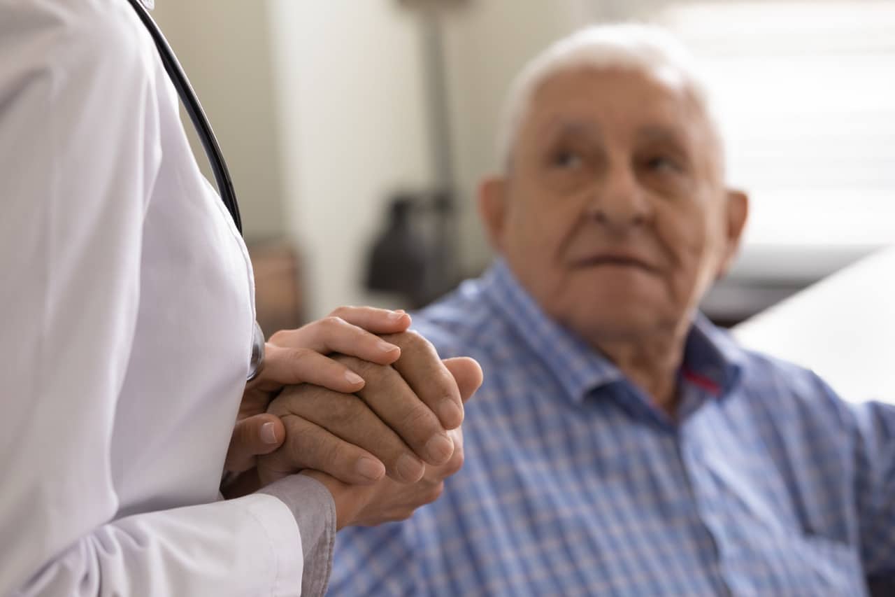 a doctor showing compassion to a senior cancer patient