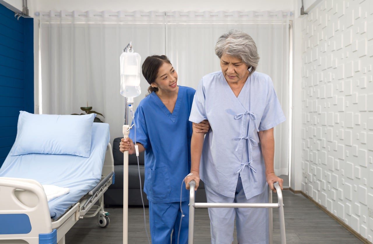 a nurse helping an elderly patient on crutches