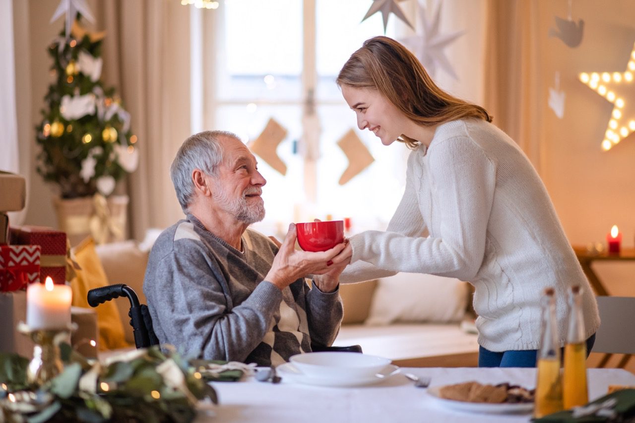 a woman caring for her grandfather during the holidays