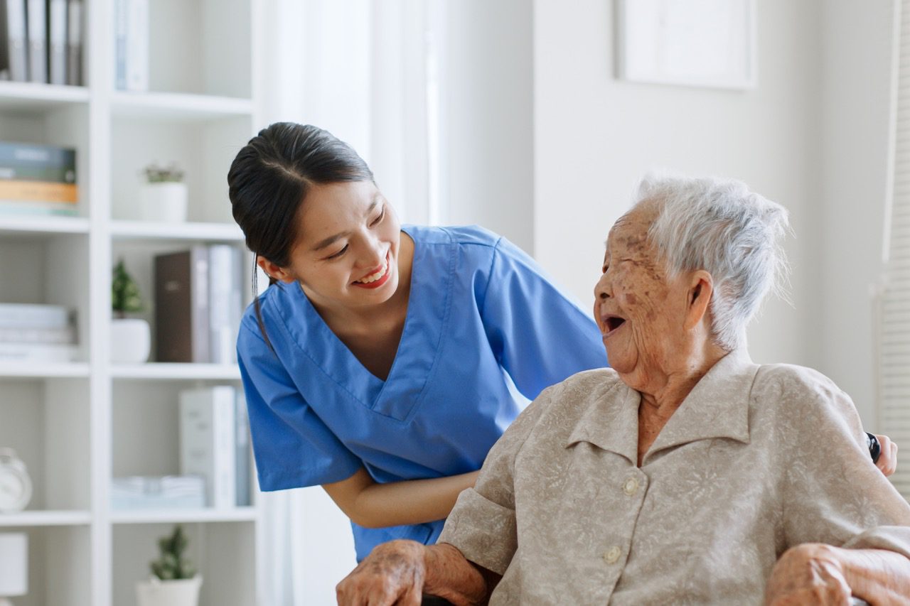 An elderly woman being cared for in an assisted living facility