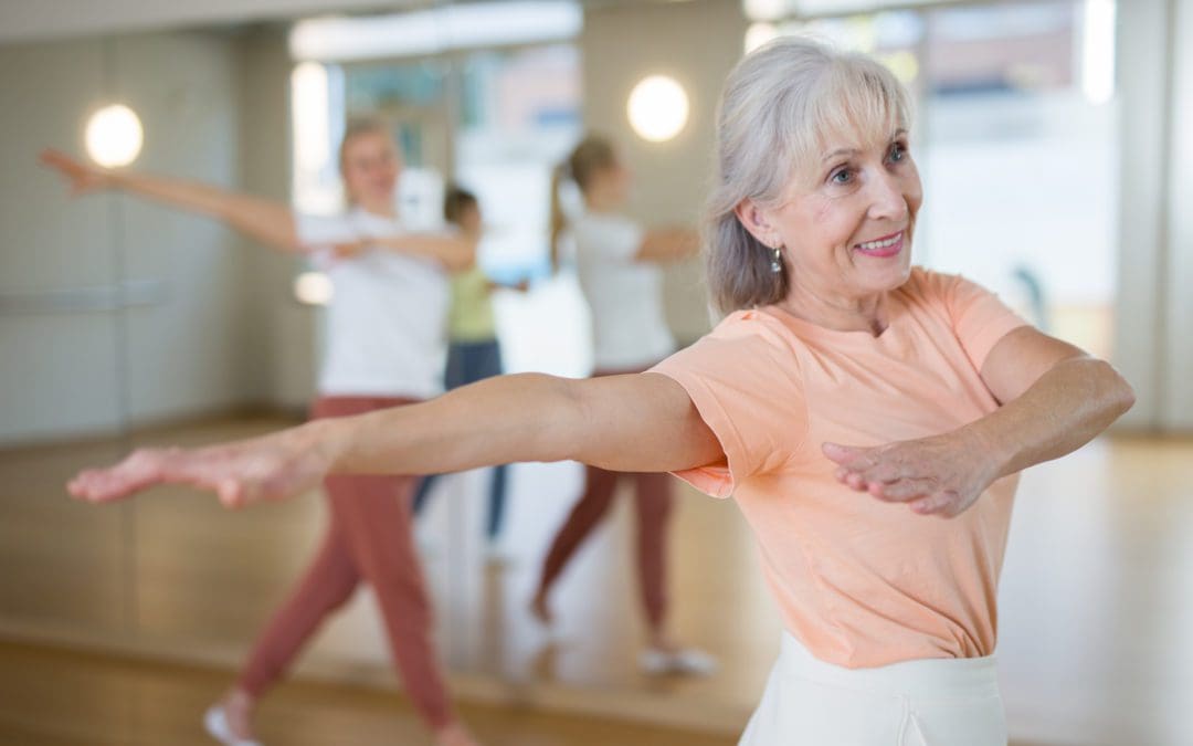 A senior woman dancing happily