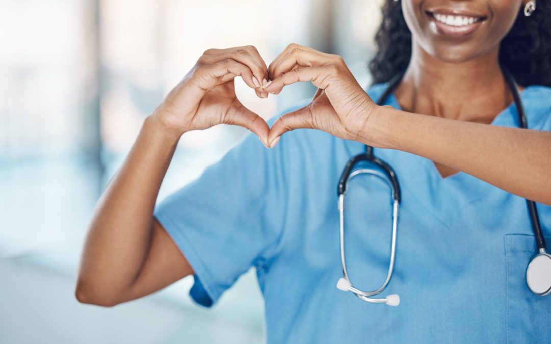 Woman nurse making a heart shape with her hands