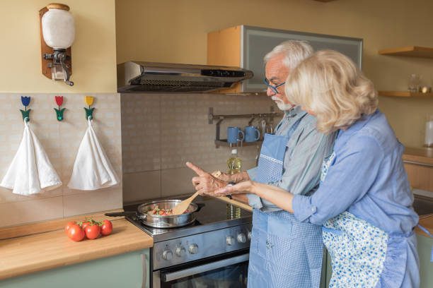 seniors cooking food in kitchen